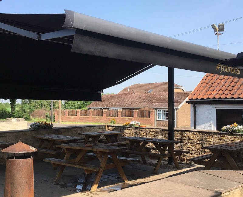 Outdoor seating butterfly awning for pub