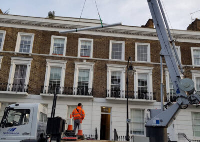 Crane lifting awning up to Penthouse Balcony