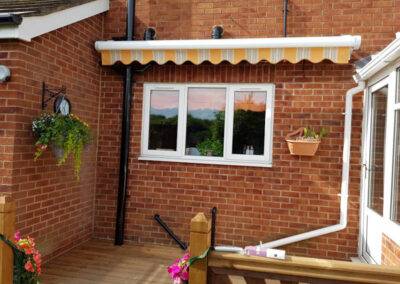 Orange Striped Bobcat Patio Awning - Retracted